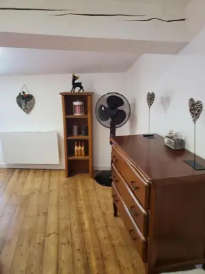 a room with a dresser and a desk with aumedumedoster on top at Charmante Petite Maison Audoise in Trausse