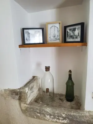 two bottles sitting on a shelf on a wall at Charmante Petite Maison Audoise in Trausse