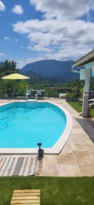 a large swimming pool with a view of a mountain at La maison d'Aude in Quillan