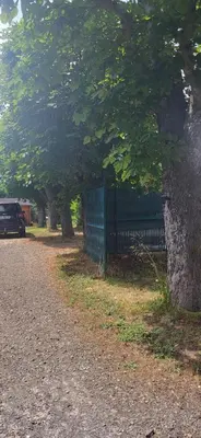 a fence on the side of a road with trees at La maison d'Aude in Quillan