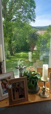 a table with pictures and a view of a window at La maison d'Aude in Quillan