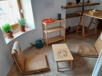 a living room with a chair and a table at La Petite Tour de Puivert in Puivert