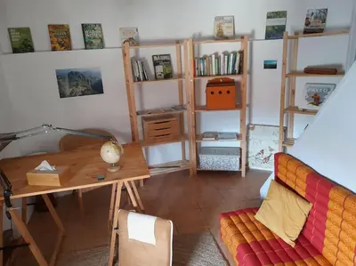 a living room with a desk and a couch at La Petite Tour de Puivert in Puivert