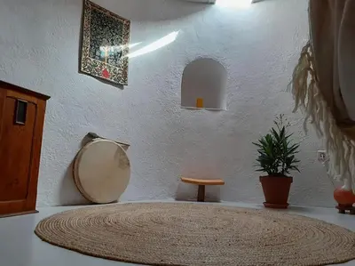 a room with a round table with a potted plant at La Petite Tour de Puivert in Puivert
