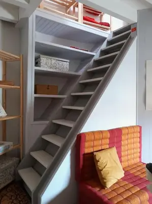 a stairway with a couch in a living room at La Petite Tour de Puivert in Puivert