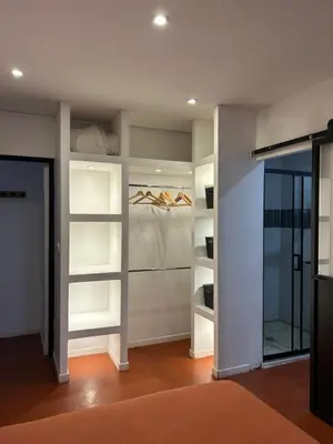 a walk in closet with white shelves in a room at T2 climatisé - Près des plages in Narbonne