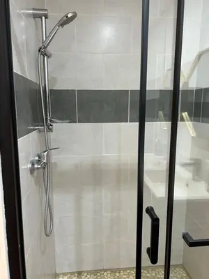 a shower with a glass door in a bathroom at T2 climatisé - Près des plages in Narbonne