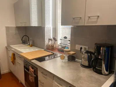 a kitchen with a sink and a counter top at T2 climatisé - Près des plages in Narbonne