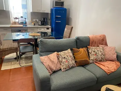 a living room with a couch with pillows on it at T2 climatisé - Près des plages in Narbonne