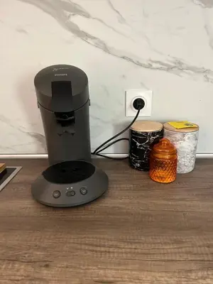 a coffee maker sitting on top of a table at Grand T2 climatisé avec jardin et spa in Narbonne