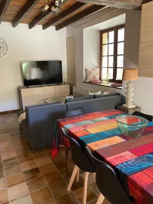 a living room with a couch and a table at Maison 2 chambres avec cour intérieure in Alet-les-Bains