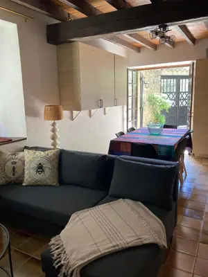 a living room with a couch and a table at Maison 2 chambres avec cour intérieure in Alet-les-Bains
