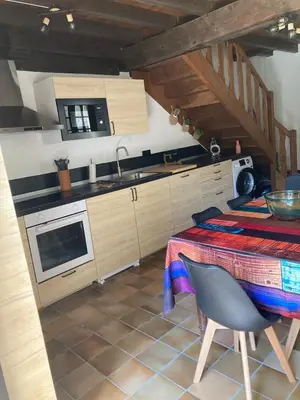 a kitchen with a table and a sink and a stove at Maison 2 chambres avec cour intérieure in Alet-les-Bains