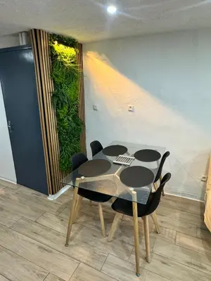 a dining room with a table and some chairs at Charmante maison de village in Bram