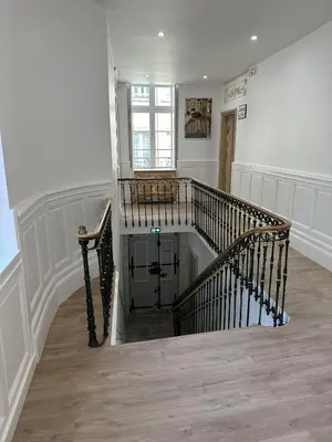 a hallway with a spiral staircase in a house at Studio Cosy du Cloitre in Narbonne