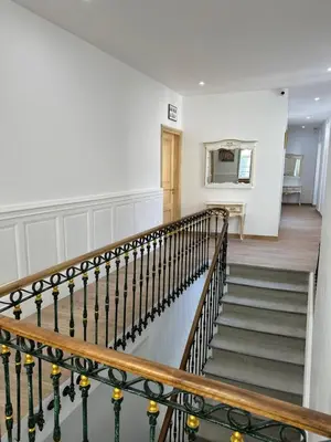 a staircase in a home with white walls at Studio familial du Cloitre in Narbonne