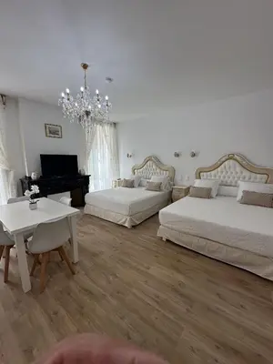 a large bedroom with two beds and a piano at Studio familial du Cloitre in Narbonne