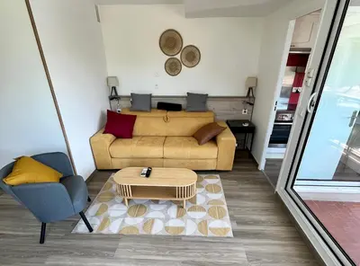 a living room with a couch and a coffee table at L'appart D79 in Gruissan