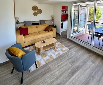a living room with a couch and a table at L'appart D79 in Gruissan