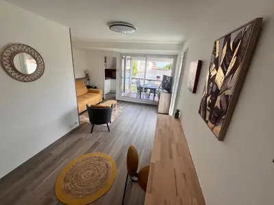 a living room with a couch and a table at L'appart D79 in Gruissan