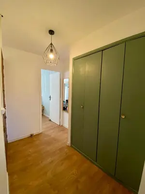 a room with green cabinets and a hallway at Chez Isa et Thomas in Narbonne