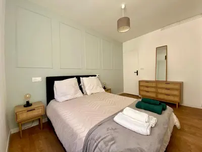 a bedroom with a large bed with towels on it at Chez Isa et Thomas in Narbonne
