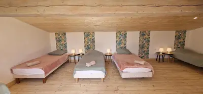 a room with two beds and candles on the wall at Dortoir Gîte d'étapes 