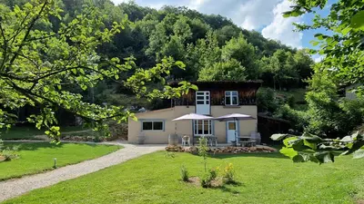 a house in the middle of a green yard at Dortoir Gîte d'étapes 