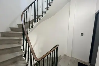 a staircase in a home with white walls at Le Moderniste Proche des Halles et Cathédrale in Narbonne