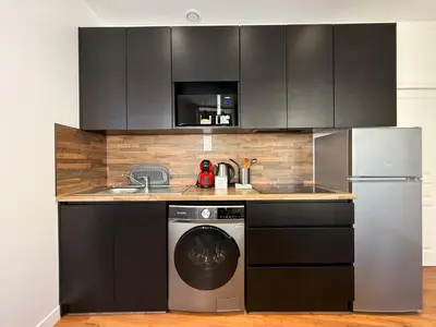 a kitchen with a sink and a dishwasher at Le Moderniste Proche des Halles et Cathédrale in Narbonne