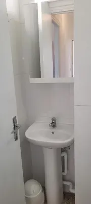 a white bathroom with a sink and a mirror at Superb T2 near the beach of Port-la-Nouvelle in Port-la-Nouvelle