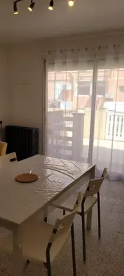a white table and chairs in a room with a window at Superb T2 near the beach of Port-la-Nouvelle in Port-la-Nouvelle