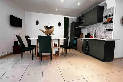 a kitchen with a table and chairs in a room at T3 6 couchages grands buffets et plages in Narbonne