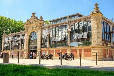 a large building with motorcycles parked in front of it at T3 6 couchages grands buffets et plages in Narbonne