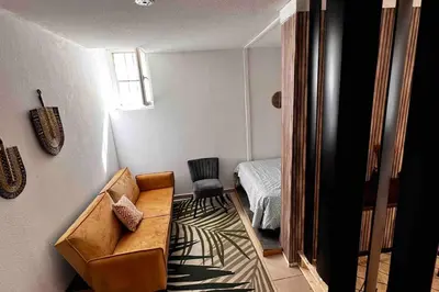 a living room with a couch and a bedroom at T3 6 couchages grands buffets et plages in Narbonne