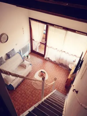 a room with a bed and a staircase in a room at Appartement 600M de la plage in Port-la-Nouvelle