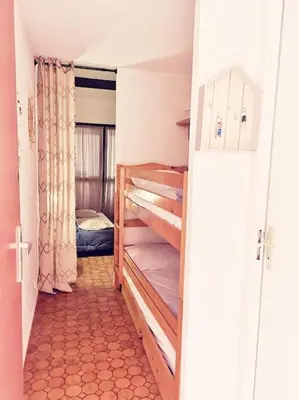 a small room with a room with bunk beds in it at Appartement 600M de la plage in Port-la-Nouvelle