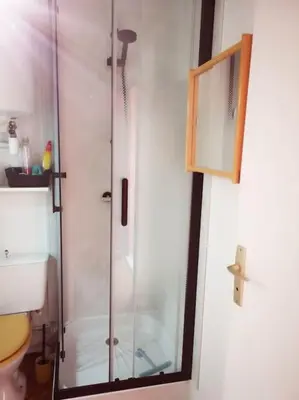 a shower with a glass door in a bathroom at Appartement 600M de la plage in Port-la-Nouvelle