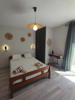a bedroom with a bed with two towels on it at Entre canal et garrigue in Roubia