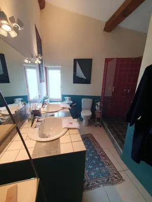 a large bathroom with two sinks and a toilet at Le Clos Ste Anne in Bizanet