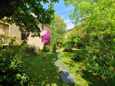 a garden with a path in the grass at Le Clos Ste Anne in Bizanet