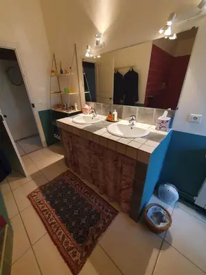 a bathroom with two sinks and a large mirror at Le Clos Ste Anne in Bizanet