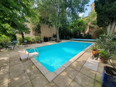 a swimming pool in a yard with trees at Le Clos Ste Anne in Bizanet