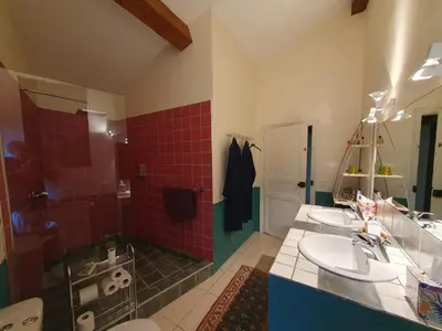 a bathroom with two sinks and a shower at Le Clos Ste Anne in Bizanet
