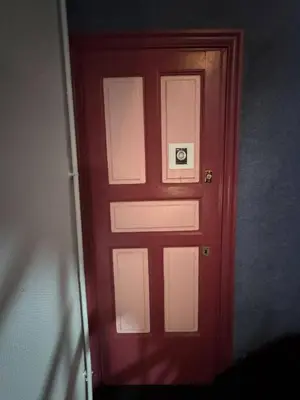 a red door with a sign on it at Chambre Lits Jumeaux in Mirepoix