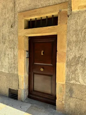 a large wooden door in a stone building at Chambre Lits Jumeaux in Mirepoix