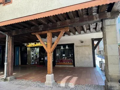 a building with awning in front of a store at Chambre Lits Jumeaux in Mirepoix