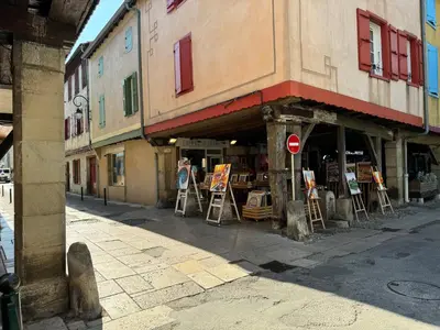 a building with paintings on display in a street at Chambre Lits Jumeaux in Mirepoix