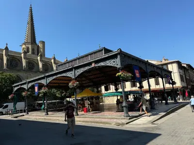 a man riding a skateboard in front of a building at Chambre Lits Jumeaux in Mirepoix