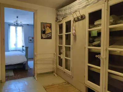 a room with glass doors and a bedroom with a bed at Ceps Cottage sleeps 6 with free wifi near the river in Roquebrun